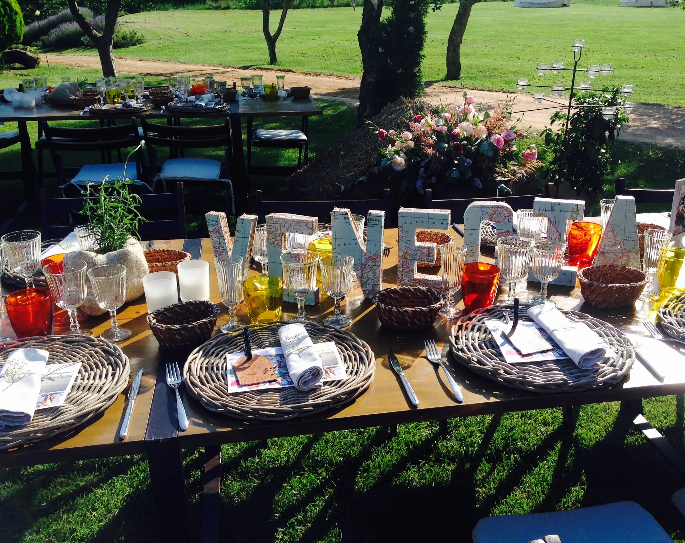 Food table in the garden with large coloured letters, bowls and sharing plates